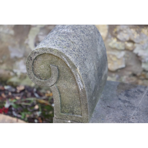 1333 - A PAIR OF CARVED STONE GARDEN BENCHES. with scroll end supports to a rectangular seat, upon arched p... 