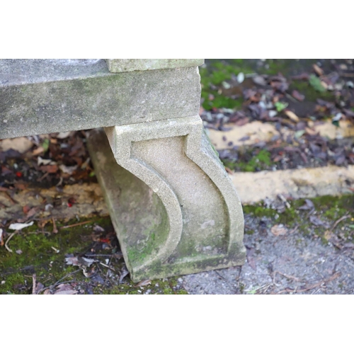 1333 - A PAIR OF CARVED STONE GARDEN BENCHES. with scroll end supports to a rectangular seat, upon arched p... 