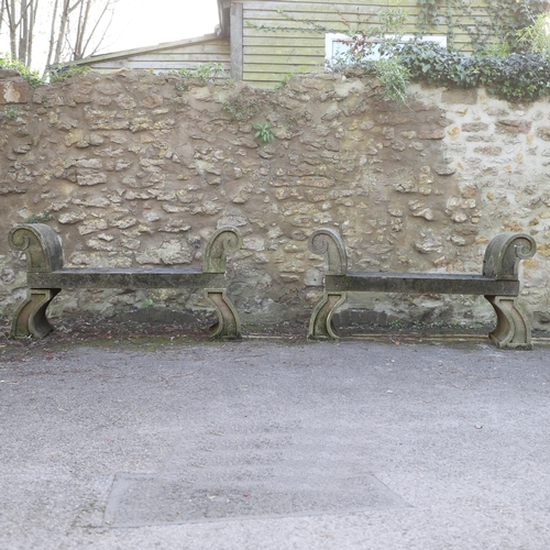 1333 - A PAIR OF CARVED STONE GARDEN BENCHES. with scroll end supports to a rectangular seat, upon arched p... 