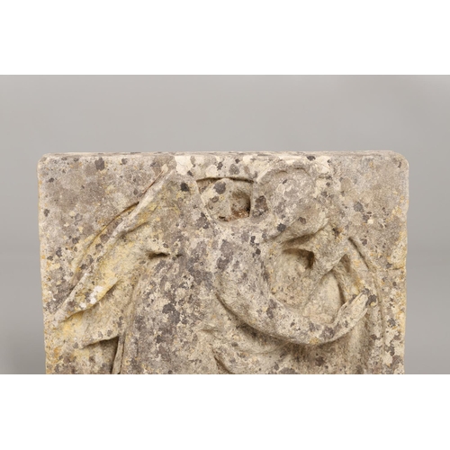 1336 - A CARVED LIMESTONE PANEL. 16th century, possibly earlier, depicting an angel in relief, 40cm x 35cm.