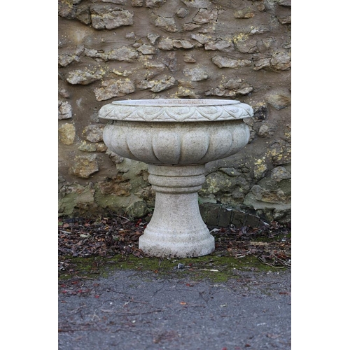 1337 - A PAIR OF LARGE CARVED GRANITE URNS. of circular lobed form, on turned column bases, height 52cm, wi... 