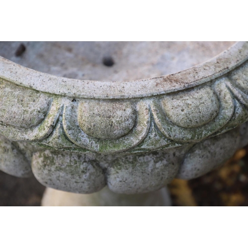 1337 - A PAIR OF LARGE CARVED GRANITE URNS. of circular lobed form, on turned column bases, height 52cm, wi... 