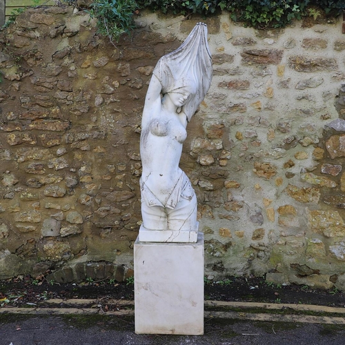 1338 - A CARVED MARBLE FIGURE. depicting a nude female removing her clothes, on a rectangular plinth, heigh... 