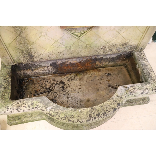 1339 - A LARGE RECONSTITUTED STONE WALL FOUNTAIN. the arched back with floral rosettes above a basin of sha... 