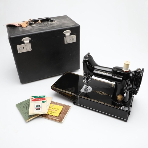 515 - CASED PORTABLE SINGER SEWING MACHINE - 221K. A cased Singer 221K portable sewing machine, with it's ... 