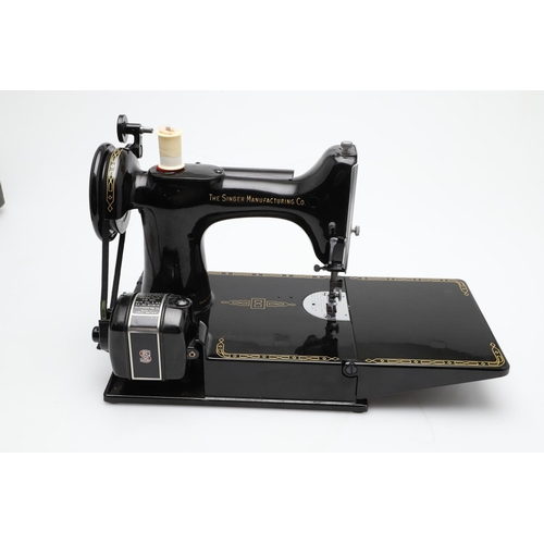 515 - CASED PORTABLE SINGER SEWING MACHINE - 221K. A cased Singer 221K portable sewing machine, with it's ... 