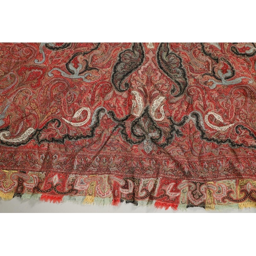 523 - ANTIQUE PAISLEY SHAWL. Probably late 19thc, a square shaped woollen shawl, in typical colours with b... 