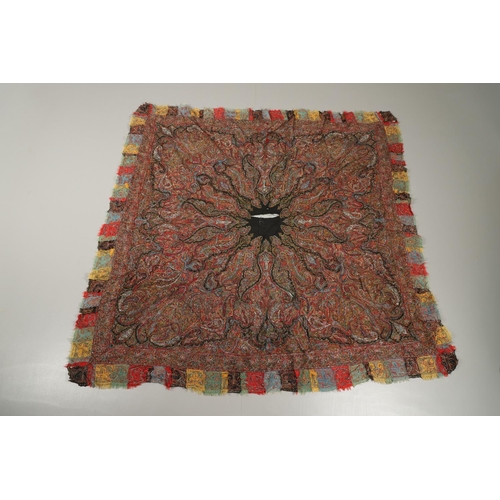 523 - ANTIQUE PAISLEY SHAWL. Probably late 19thc, a square shaped woollen shawl, in typical colours with b... 