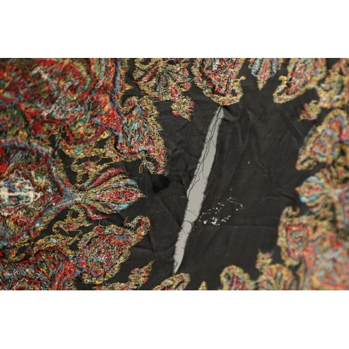 523 - ANTIQUE PAISLEY SHAWL. Probably late 19thc, a square shaped woollen shawl, in typical colours with b... 