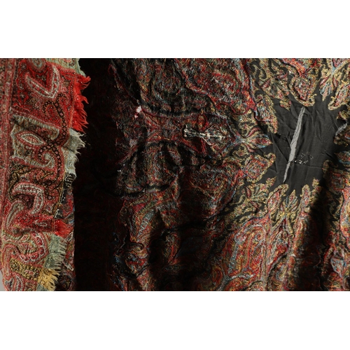 523 - ANTIQUE PAISLEY SHAWL. Probably late 19thc, a square shaped woollen shawl, in typical colours with b... 