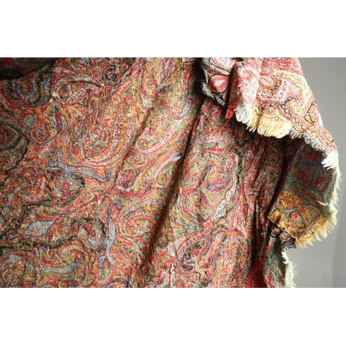 523 - ANTIQUE PAISLEY SHAWL. Probably late 19thc, a square shaped woollen shawl, in typical colours with b... 