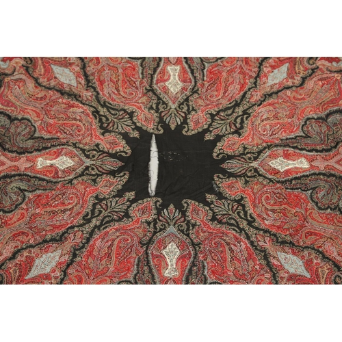 523 - ANTIQUE PAISLEY SHAWL. Probably late 19thc, a square shaped woollen shawl, in typical colours with b... 