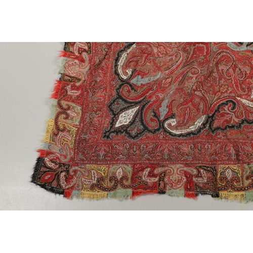 523 - ANTIQUE PAISLEY SHAWL. Probably late 19thc, a square shaped woollen shawl, in typical colours with b... 