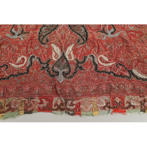 523 - ANTIQUE PAISLEY SHAWL. Probably late 19thc, a square shaped woollen shawl, in typical colours with b... 