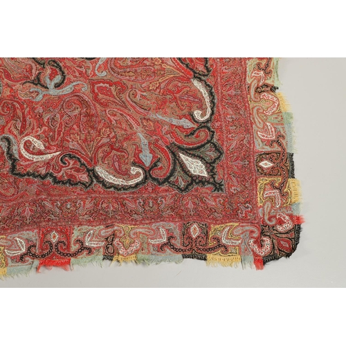 523 - ANTIQUE PAISLEY SHAWL. Probably late 19thc, a square shaped woollen shawl, in typical colours with b... 