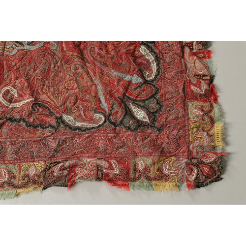 523 - ANTIQUE PAISLEY SHAWL. Probably late 19thc, a square shaped woollen shawl, in typical colours with b... 