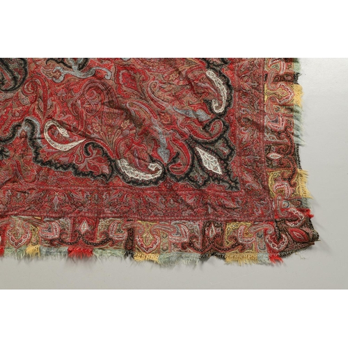 523 - ANTIQUE PAISLEY SHAWL. Probably late 19thc, a square shaped woollen shawl, in typical colours with b... 