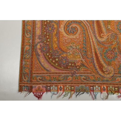 524 - VICTORIAN PAISLEY SHAWL - SIGNED. A large Paisley woollen shawl, with a coloured fringe and signed w... 