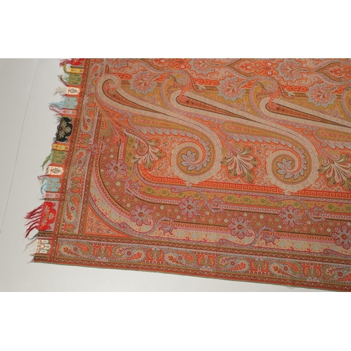 524 - VICTORIAN PAISLEY SHAWL - SIGNED. A large Paisley woollen shawl, with a coloured fringe and signed w... 