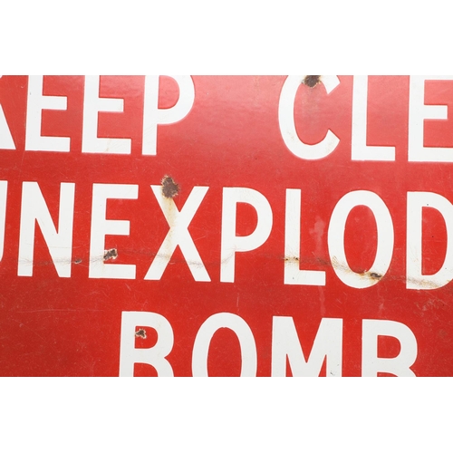 529 - VINTAGE ENAMEL SIGN - 'KEEP CLEAR UNEXPLODED BOMB'. A vintage red enamel sign with white lettering, ... 