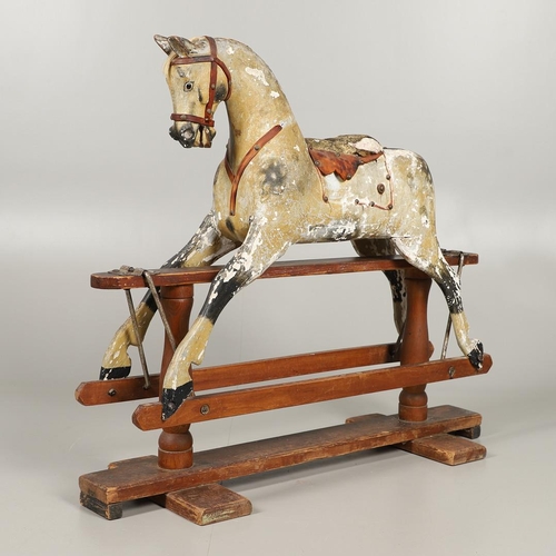 532 - F H AYRES - ANTIQUE ROCKING HORSE. A carved and painted pine rocking horse, mounted with a padded se... 