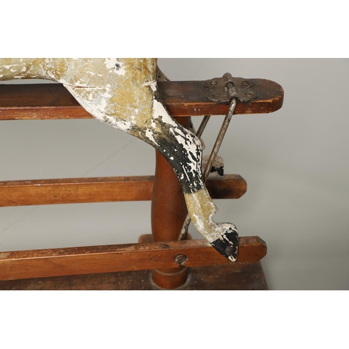 532 - F H AYRES - ANTIQUE ROCKING HORSE. A carved and painted pine rocking horse, mounted with a padded se... 