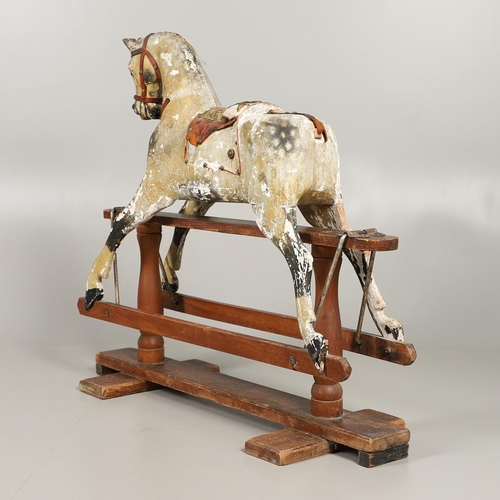 532 - F H AYRES - ANTIQUE ROCKING HORSE. A carved and painted pine rocking horse, mounted with a padded se... 