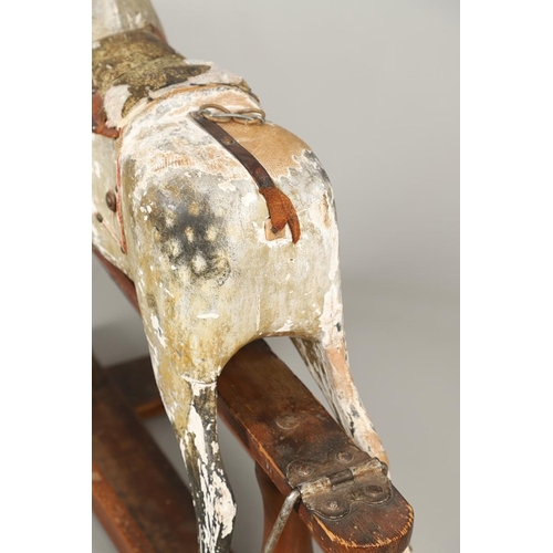 532 - F H AYRES - ANTIQUE ROCKING HORSE. A carved and painted pine rocking horse, mounted with a padded se... 