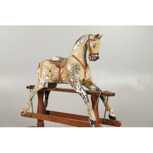 532 - F H AYRES - ANTIQUE ROCKING HORSE. A carved and painted pine rocking horse, mounted with a padded se... 