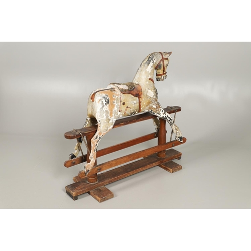 532 - F H AYRES - ANTIQUE ROCKING HORSE. A carved and painted pine rocking horse, mounted with a padded se... 