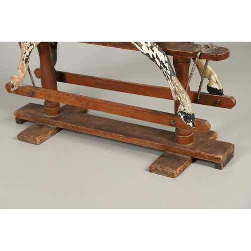 532 - F H AYRES - ANTIQUE ROCKING HORSE. A carved and painted pine rocking horse, mounted with a padded se... 