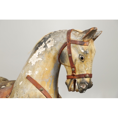 532 - F H AYRES - ANTIQUE ROCKING HORSE. A carved and painted pine rocking horse, mounted with a padded se... 