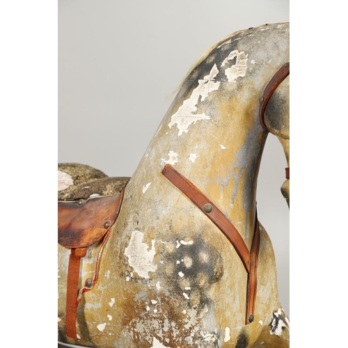 532 - F H AYRES - ANTIQUE ROCKING HORSE. A carved and painted pine rocking horse, mounted with a padded se... 