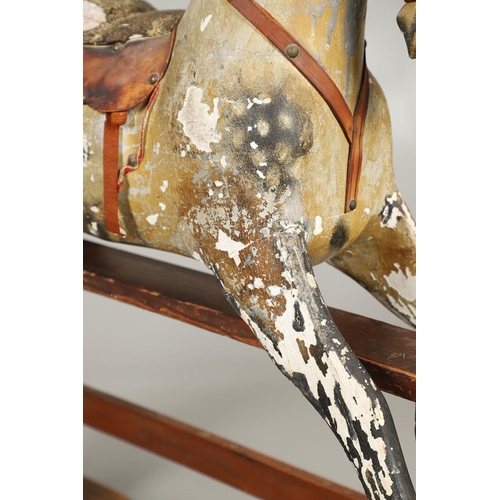 532 - F H AYRES - ANTIQUE ROCKING HORSE. A carved and painted pine rocking horse, mounted with a padded se... 