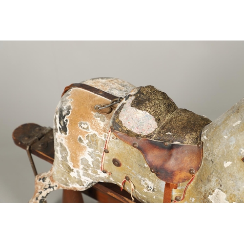 532 - F H AYRES - ANTIQUE ROCKING HORSE. A carved and painted pine rocking horse, mounted with a padded se... 