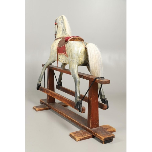 535 - ANTIQUE ROCKING HORSE. A antique painted rocking horse, fitted with a saddle and bridle and mounted ... 