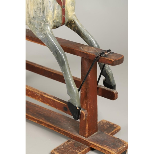 535 - ANTIQUE ROCKING HORSE. A antique painted rocking horse, fitted with a saddle and bridle and mounted ... 