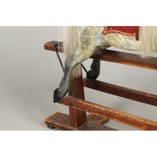 535 - ANTIQUE ROCKING HORSE. A antique painted rocking horse, fitted with a saddle and bridle and mounted ... 