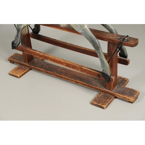 535 - ANTIQUE ROCKING HORSE. A antique painted rocking horse, fitted with a saddle and bridle and mounted ... 