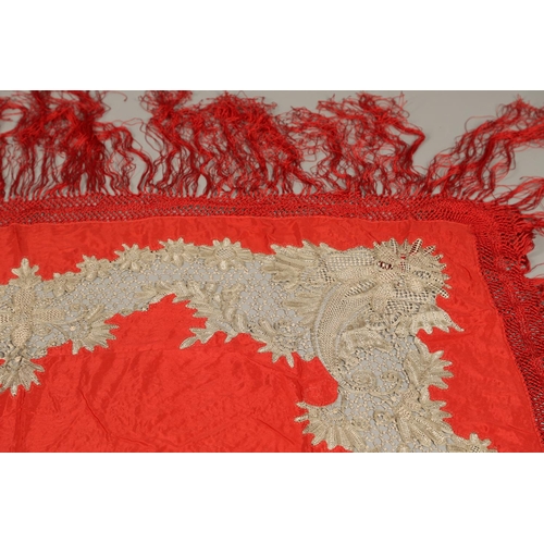 561 - ANTIQUE RED SILK & EMBROIDERED SHAWL. Probably late 19thc, the dark red silk fringed shawl with poss... 