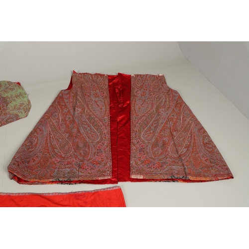 562 - ANTIQUE PAISLEY GARMENT. A late 19thc/early 20thc unfinished garment which appears to have been made... 