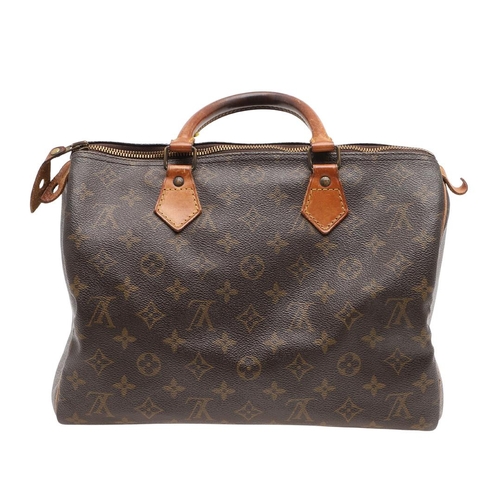 573 - LOUIS VUITTON 'SPEEDY 30' HANDBAG. A canvas monogrammed handbag, with leather trim and handles. The ... 