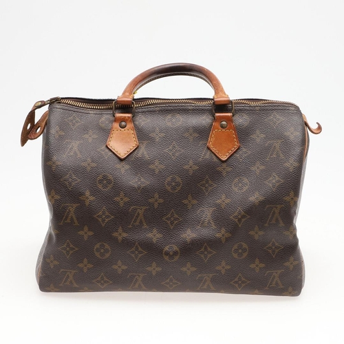 573 - LOUIS VUITTON 'SPEEDY 30' HANDBAG. A canvas monogrammed handbag, with leather trim and handles. The ... 