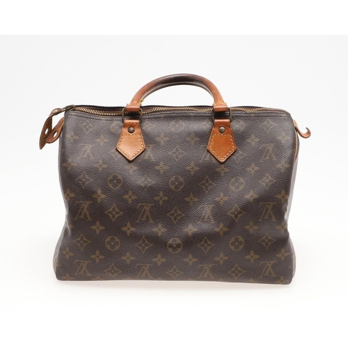 573 - LOUIS VUITTON 'SPEEDY 30' HANDBAG. A canvas monogrammed handbag, with leather trim and handles. The ... 