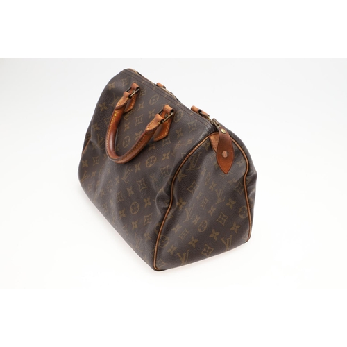 573 - LOUIS VUITTON 'SPEEDY 30' HANDBAG. A canvas monogrammed handbag, with leather trim and handles. The ... 