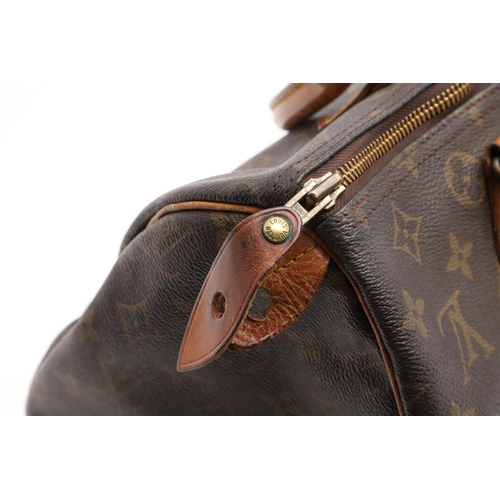 573 - LOUIS VUITTON 'SPEEDY 30' HANDBAG. A canvas monogrammed handbag, with leather trim and handles. The ... 