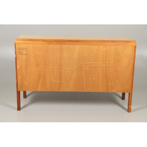 589 - MID CENTURY TEAK SIDEBOARD - MANN EGERTON, 1977. An interesting teak sideboard with a small raised b... 