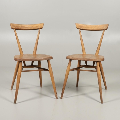 592 - TWO EARLY ERCOL STACKING DINING CHAIRS. Two circa 1950's light elm and beech stacking dining chairs,... 