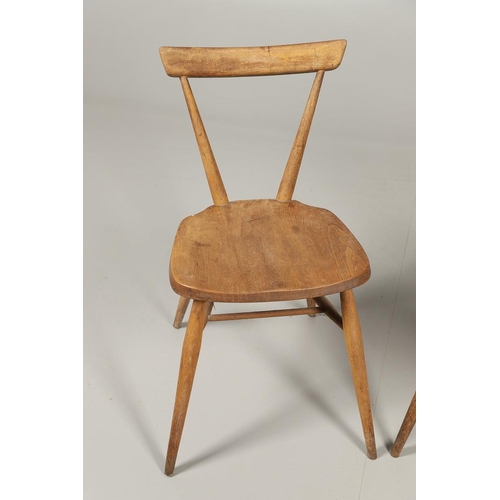 592 - TWO EARLY ERCOL STACKING DINING CHAIRS. Two circa 1950's light elm and beech stacking dining chairs,... 