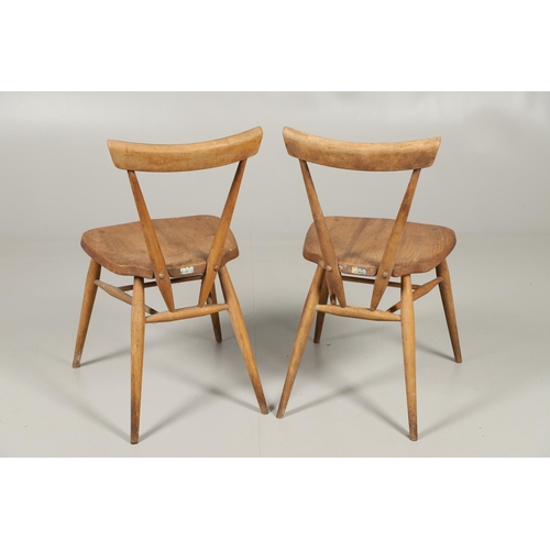 592 - TWO EARLY ERCOL STACKING DINING CHAIRS. Two circa 1950's light elm and beech stacking dining chairs,... 